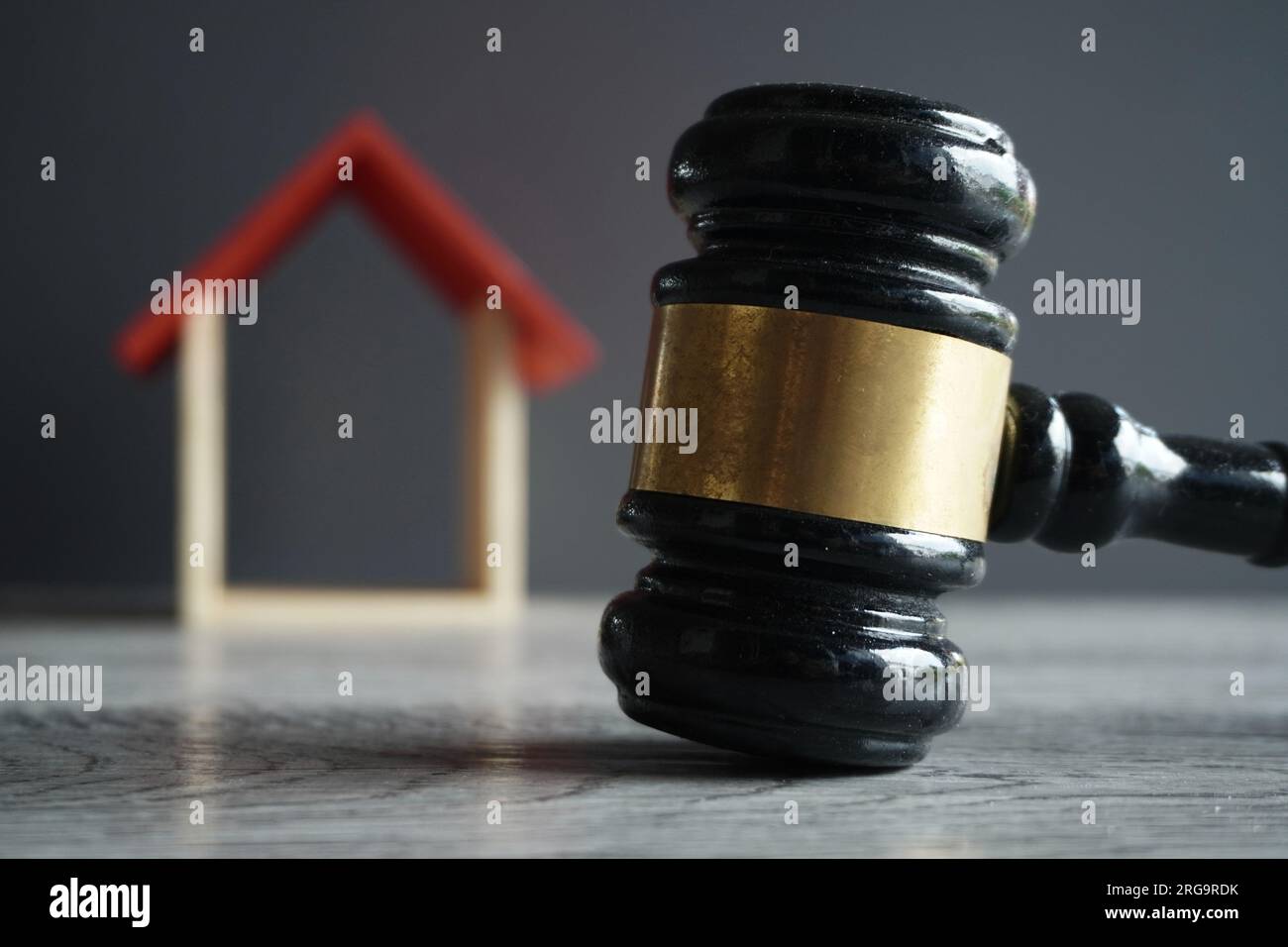 Selective focus image of judge gavel and house. Real estate law, property law and probate concept. Stock Photo