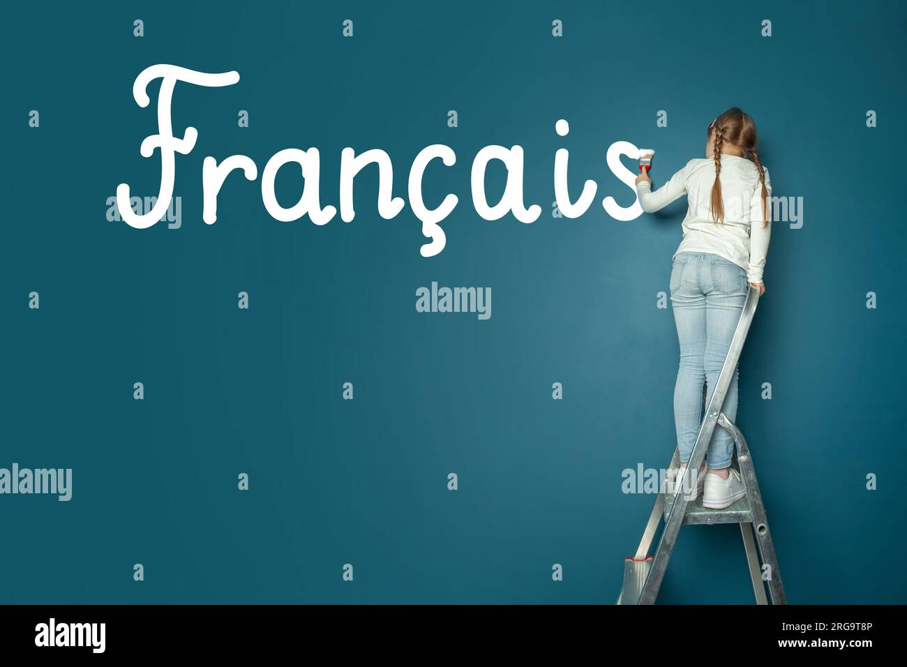 Child student girl standing on ladder and writing French language on