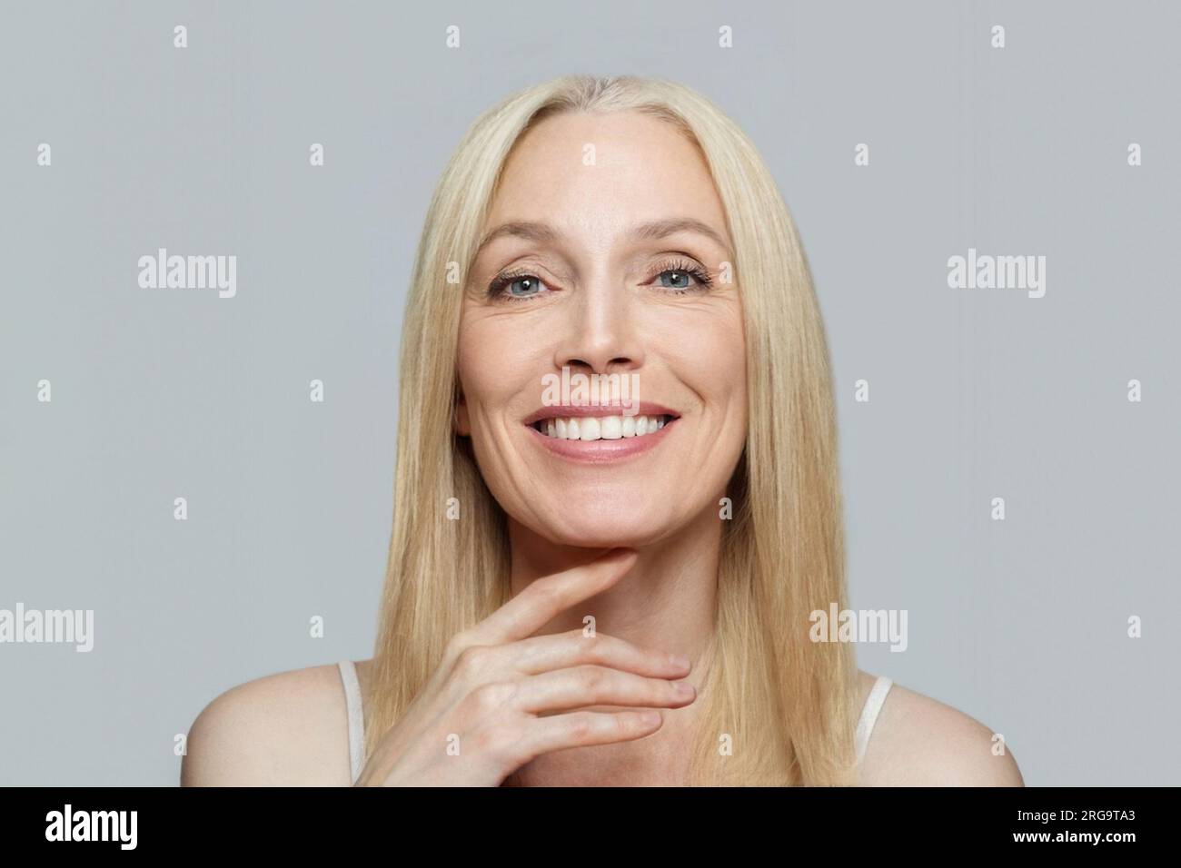 Smiling mature woman with blonde hair portrait Stock Photo - Alamy