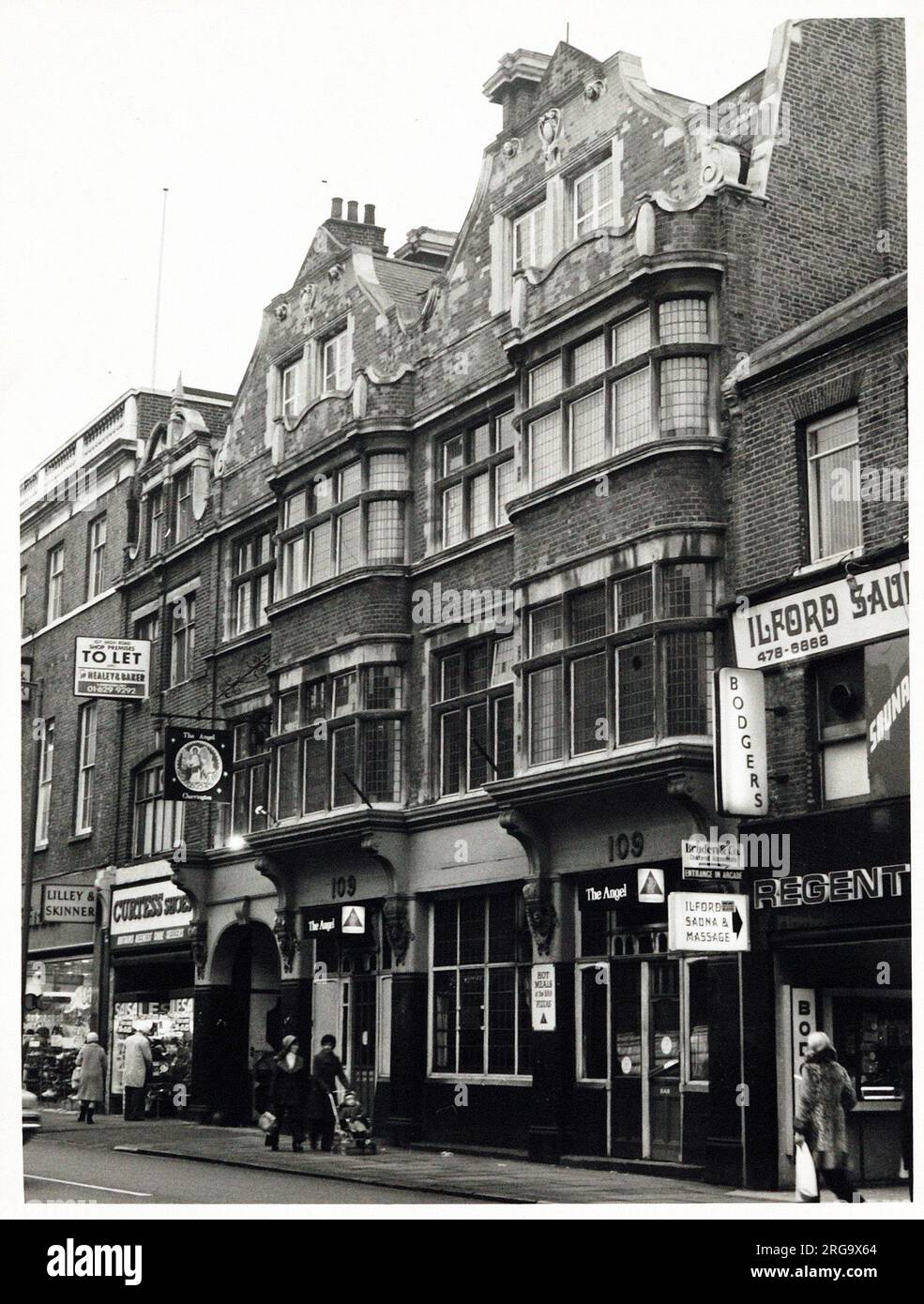 Photograph of Angel PH, Ilford (Old), Essex. The main side of the print (shown here) depicts: Right face on view of the pub.  The back of the print (available on request) details: Photographer ID for the Angel, Ilford (Old), Essex IG1 1DE. As of July 2018 . Old building now Bonmarche Stock Photo