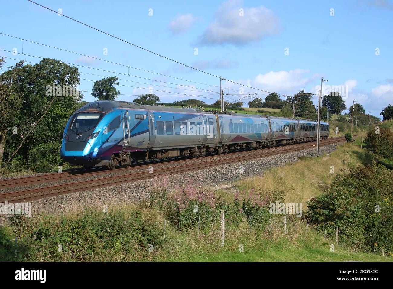 TransPennineExpress liveried class 397 civity emu express passenger electric train on West Coast Main line at Bay Horse in Lancashire 8th August 2023. Stock Photo