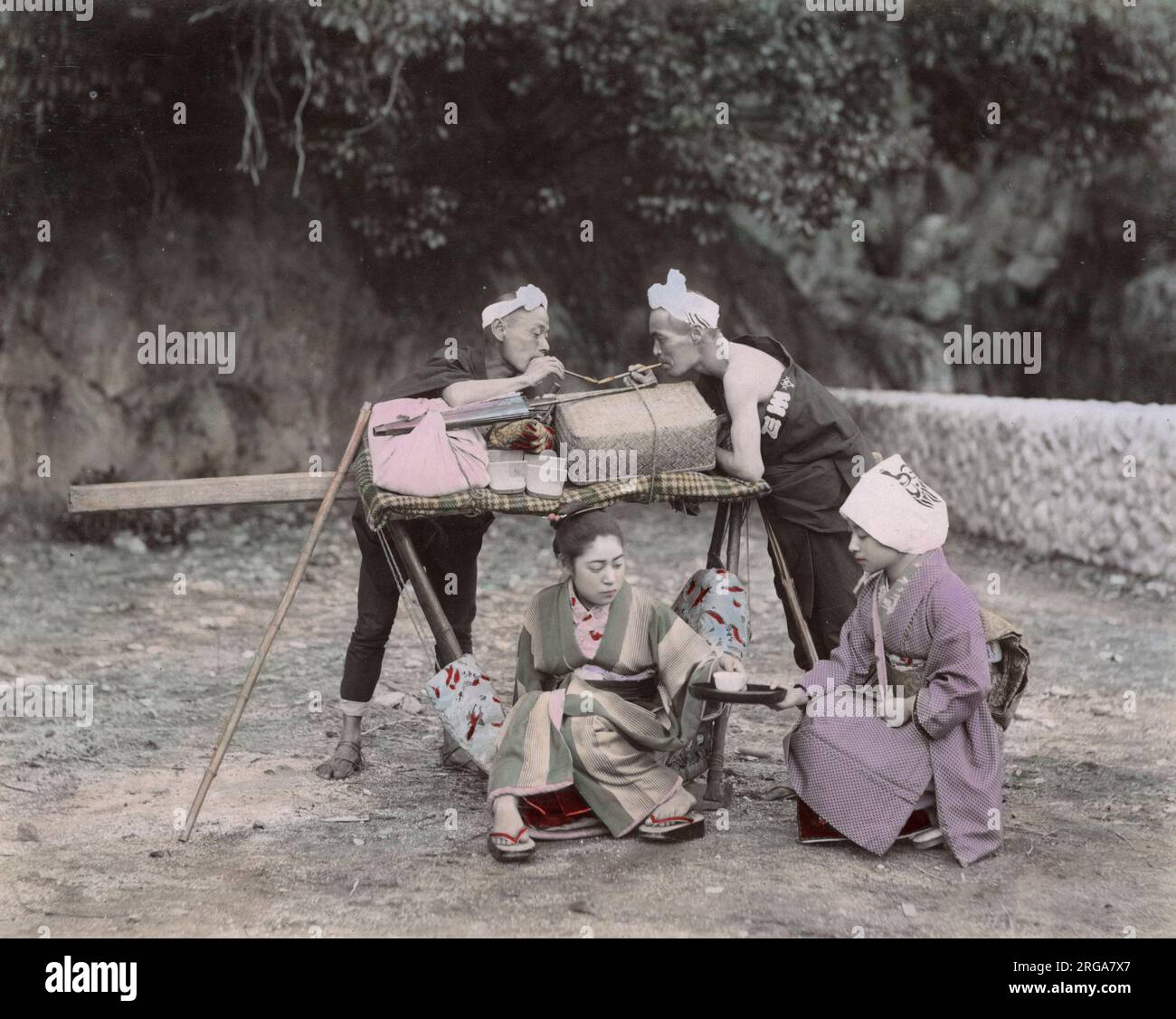 Young woman being carried in a kago, carrying chair, being served tea. Vintage 19th century photograph. Stock Photo