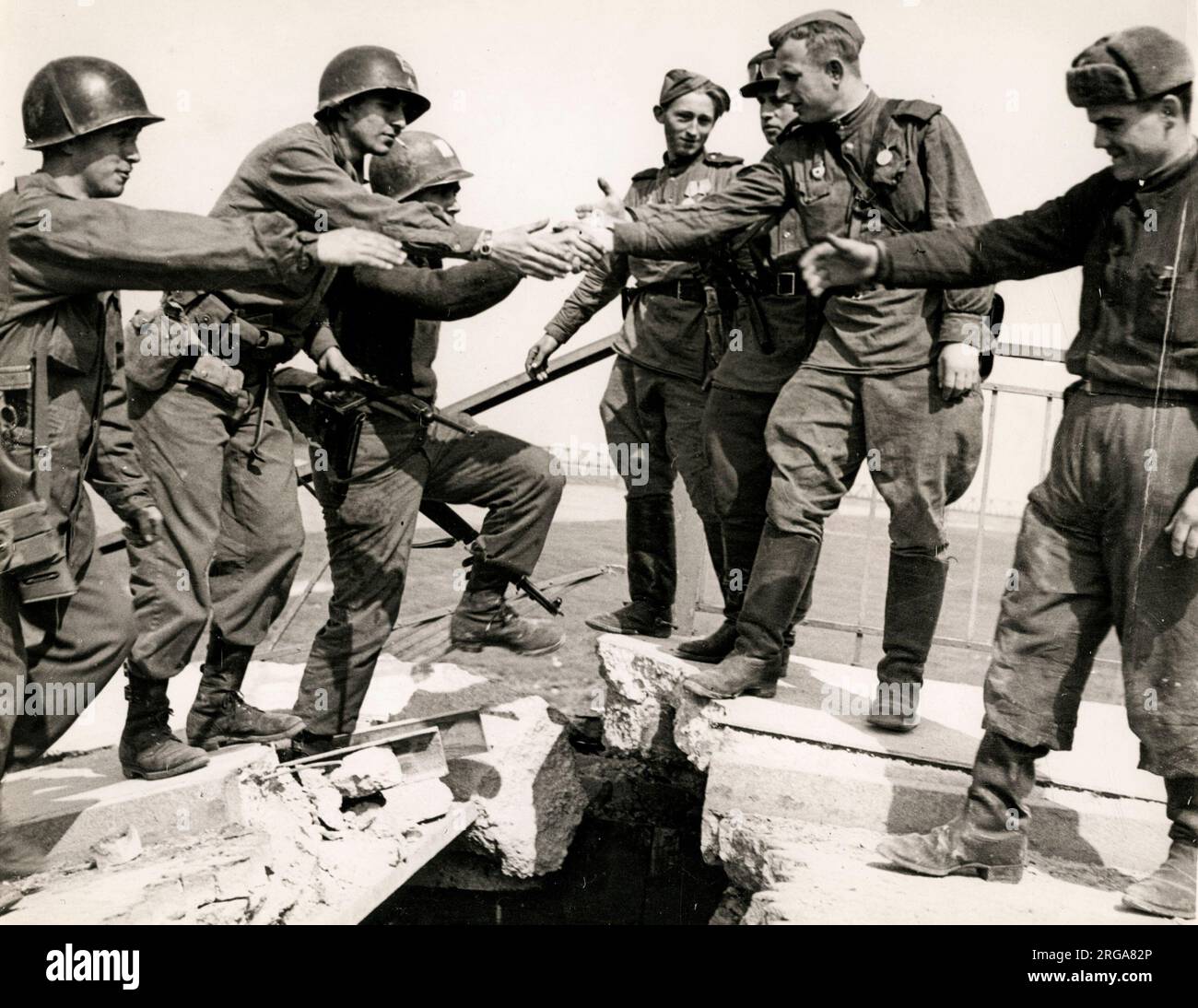 American soldiers of the First Army shake hands with Russian counterparts as the two sides meet at Torgau on the River Elbe, 1945 World War II Stock Photo