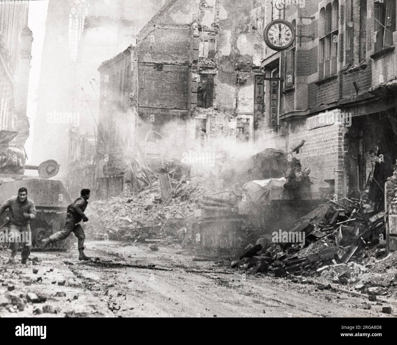 Vintage photograph World War II - fighting in the streets of Cologne Germany, near the cathedral, American tank hit by a shell Stock Photo