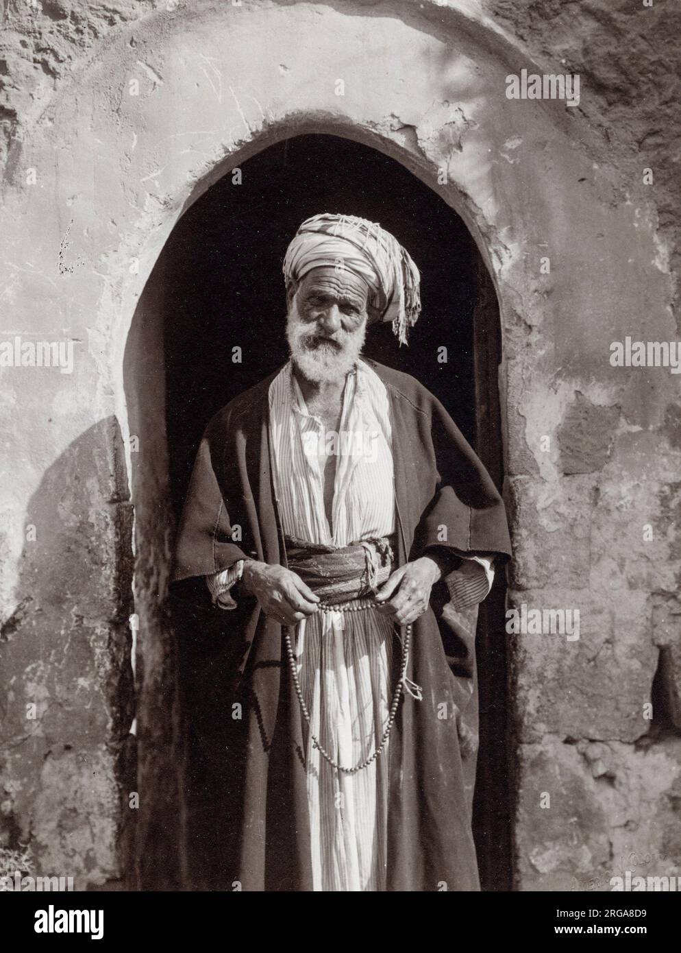 Vintage early 20th century photograph - village chief or sheikh with beads Stock Photo