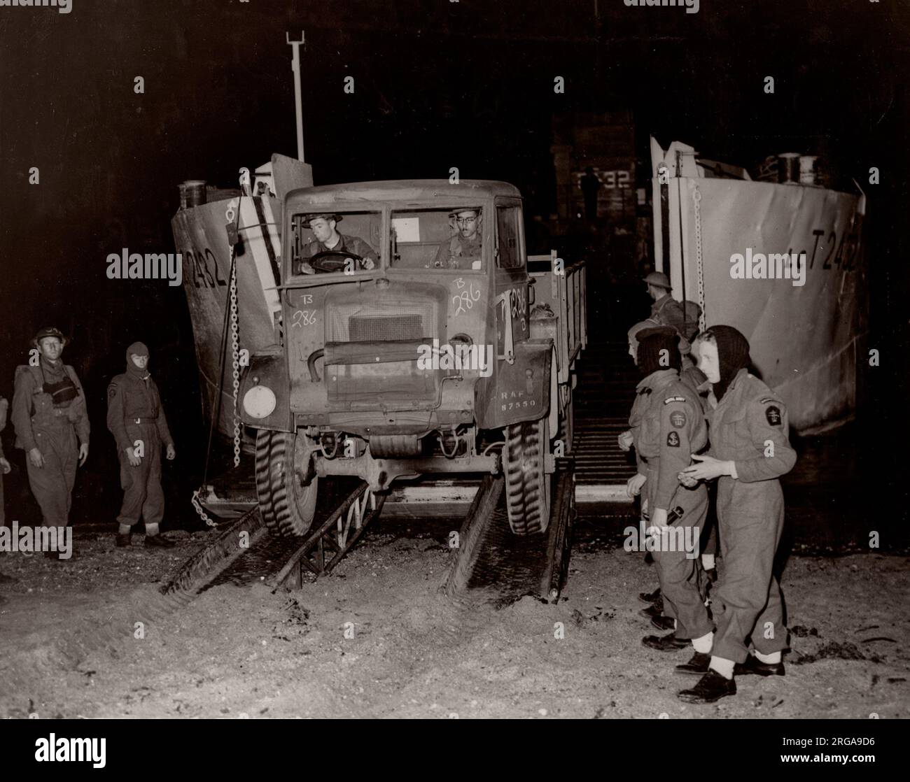 World War II WW2 - truck comes off a landing craft at night Stock Photo