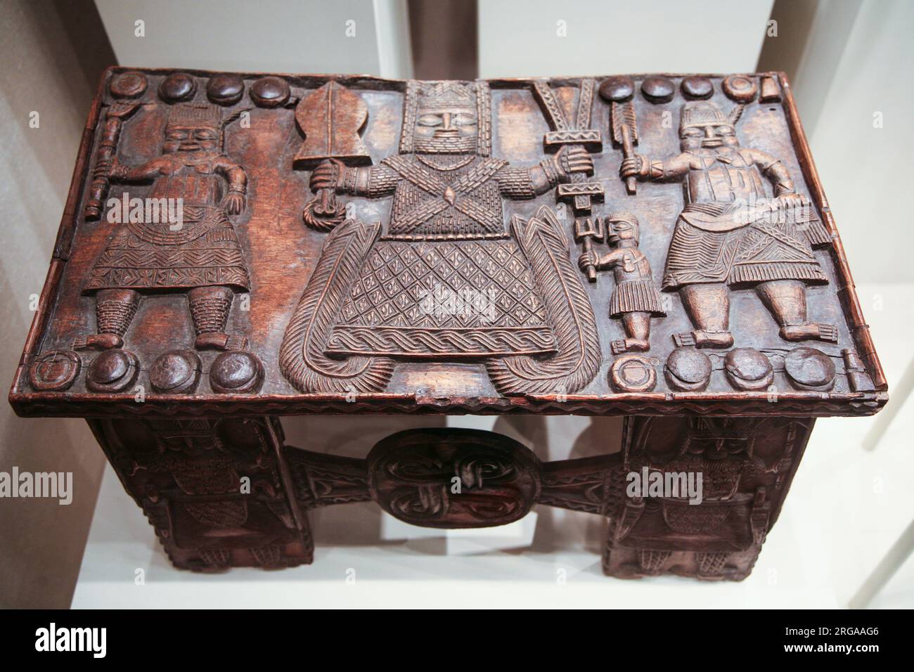 African art exhibition at the Metropolitan Museum of Art, hand carved wooden table depicting king and warriors, New York City, USA Stock Photo