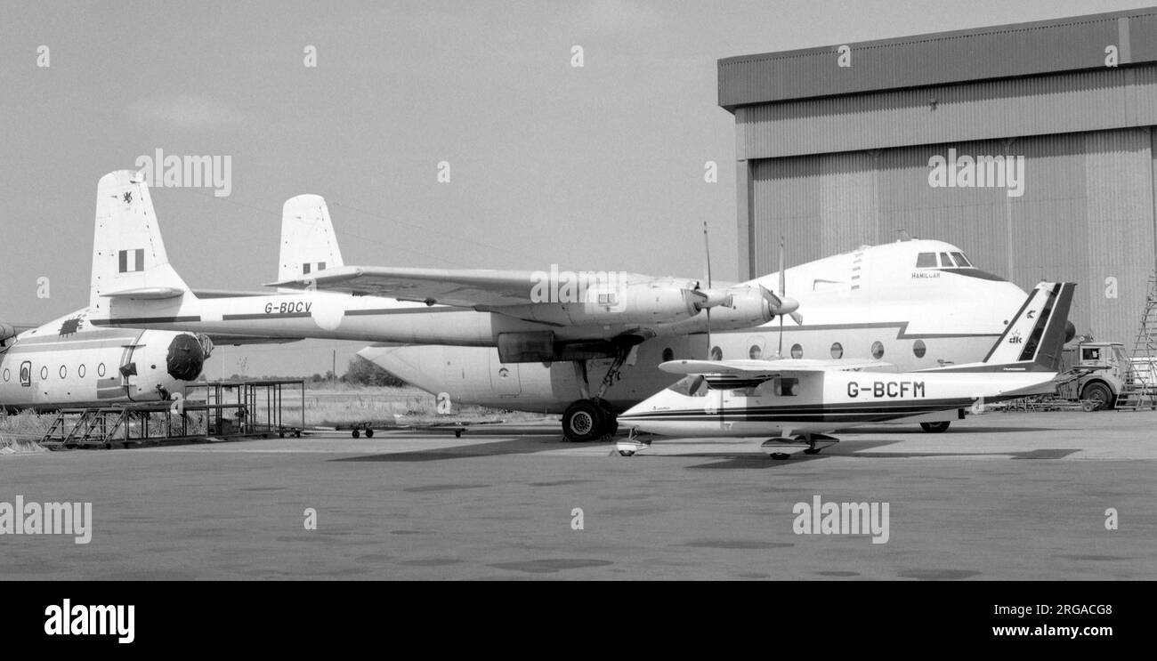 Armstrong Whitworth AW.660 Argosy C.1 G-BDCV 'Hamilcar' (ex Royal Air Force XP412), of Air Bridge Carriers, with Partenavia P.68B Victor G-BCFM, at East Midlands Airport, with an AW650 Argosy (civil version) in storage in the background. Stock Photo