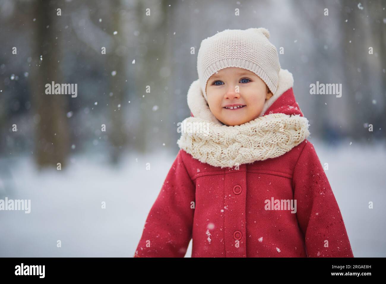 adorable-toddler-girl-on-a-day-with-heavy-snowfall-happy-child-playing