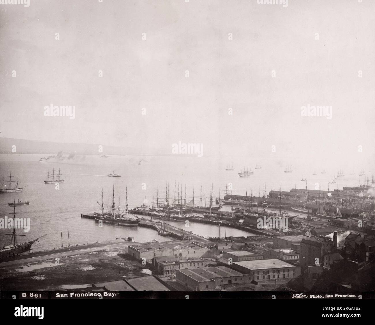 19th century vintage photograph: view of the docks, sailing ships tied ...