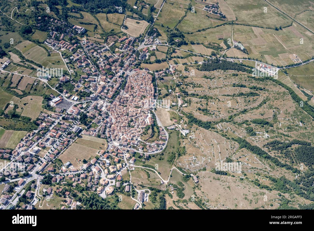 aerial landscape, from a glider plane, with historical  mountain village in green valley, shot from south in bright summer light at Rocca di Mezzo, Ap Stock Photo