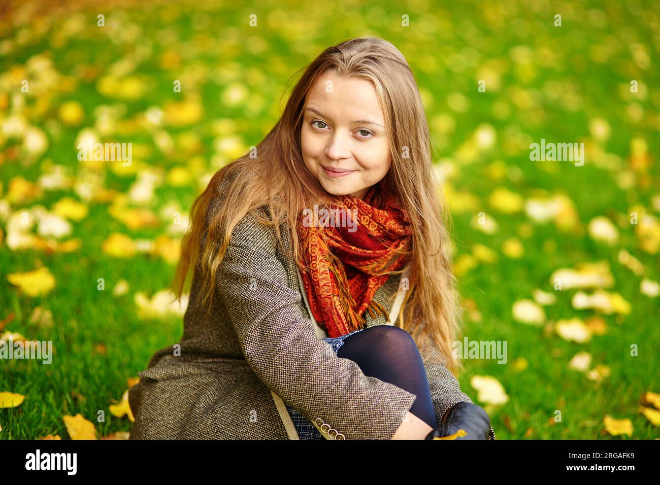Beautiful young woman in Paris sitting on the ground on a beautiful ...