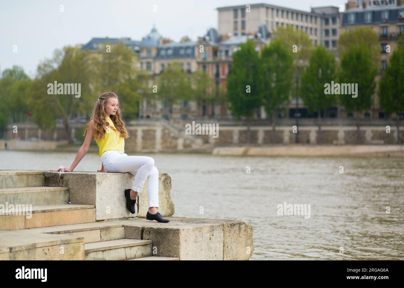 Girl relaxing on the Seine embankment in Paris Stock Photo - Alamy