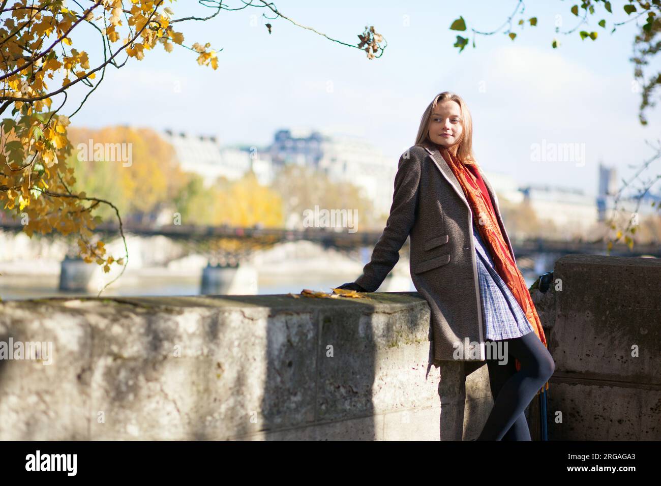 Parisian girl on the embankment on a fall day Stock Photo - Alamy