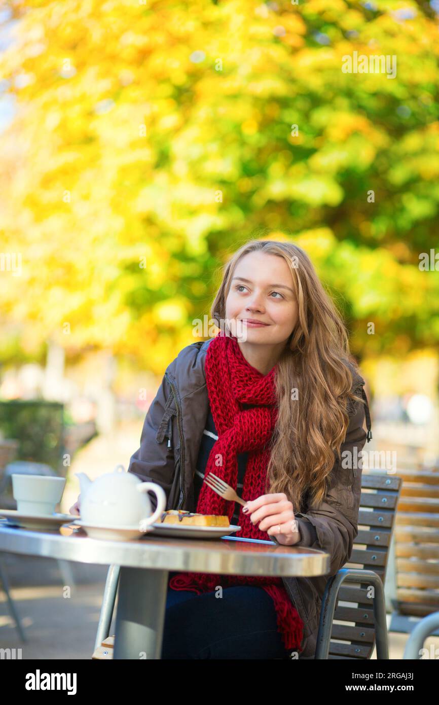 Girl eating waffles in a Parisian cafe Stock Photo