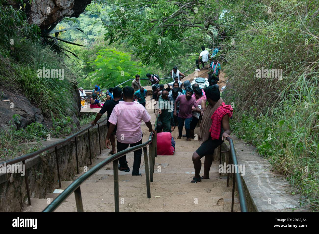 Kolli Hills, Tamil Nadu, India - July 16 2023: Crowd of people walking along the steps leading to Agaya Gangai waterfalls located in Kolli Hills of th Stock Photo