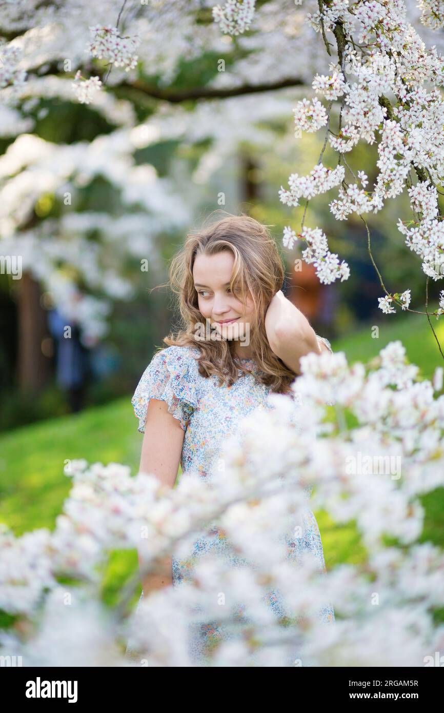 Beautiful young girl in cherry blossom garden on a spring day Stock ...