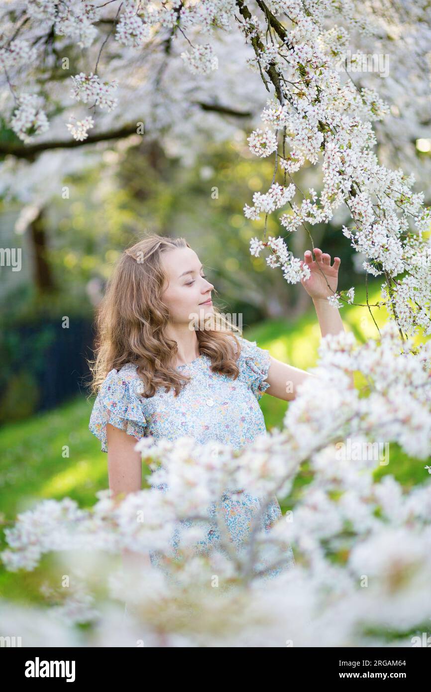 Beautiful young girl in cherry blossom garden on a spring day Stock ...