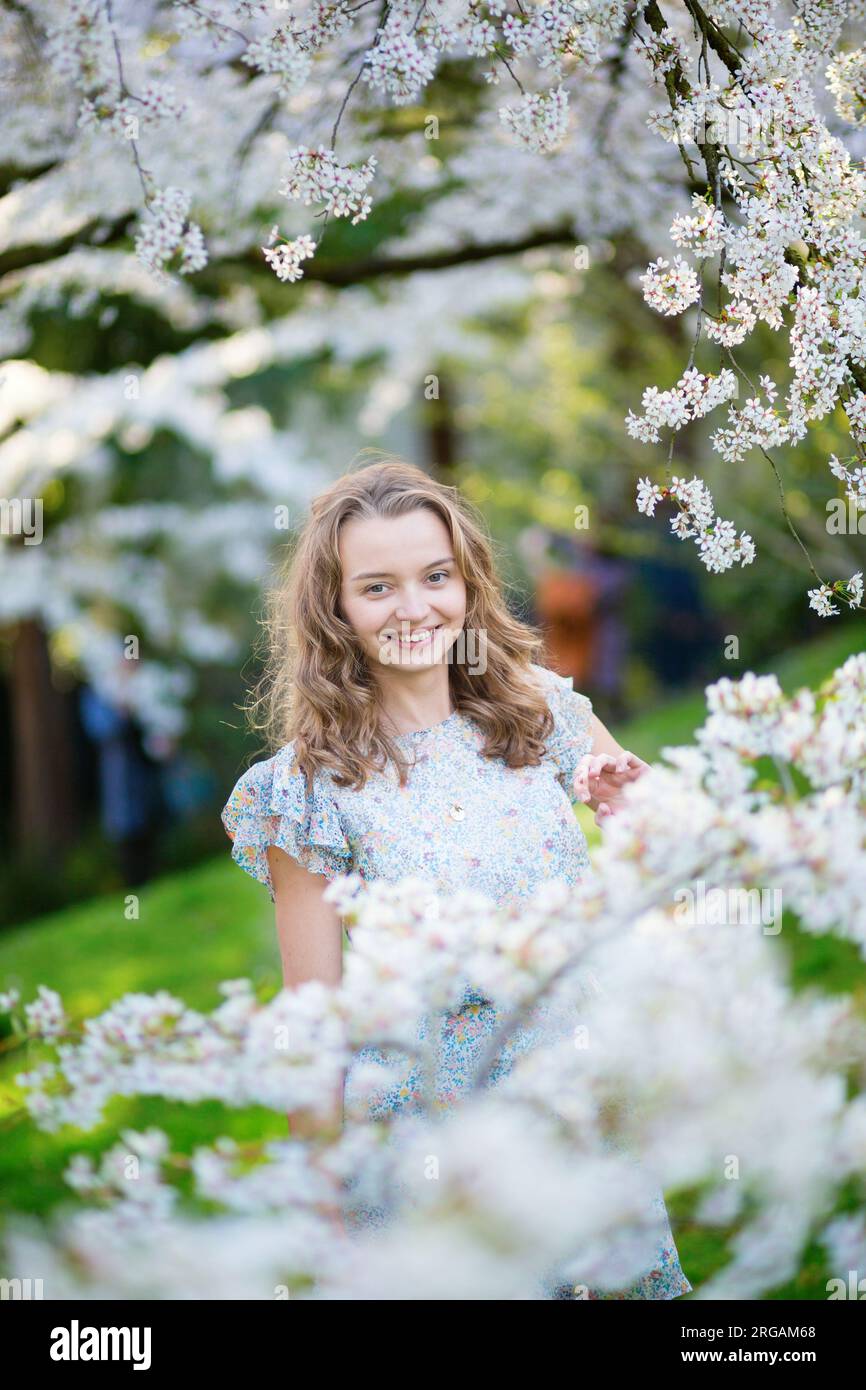 Beautiful young girl in cherry blossom garden on a spring day Stock ...