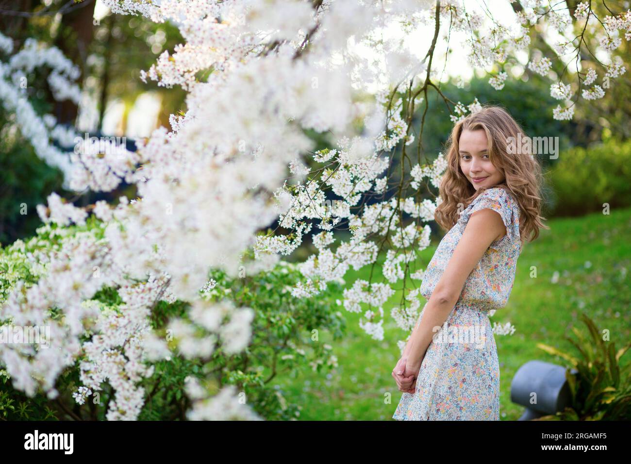 Beautiful young girl in cherry blossom garden on a spring day Stock ...