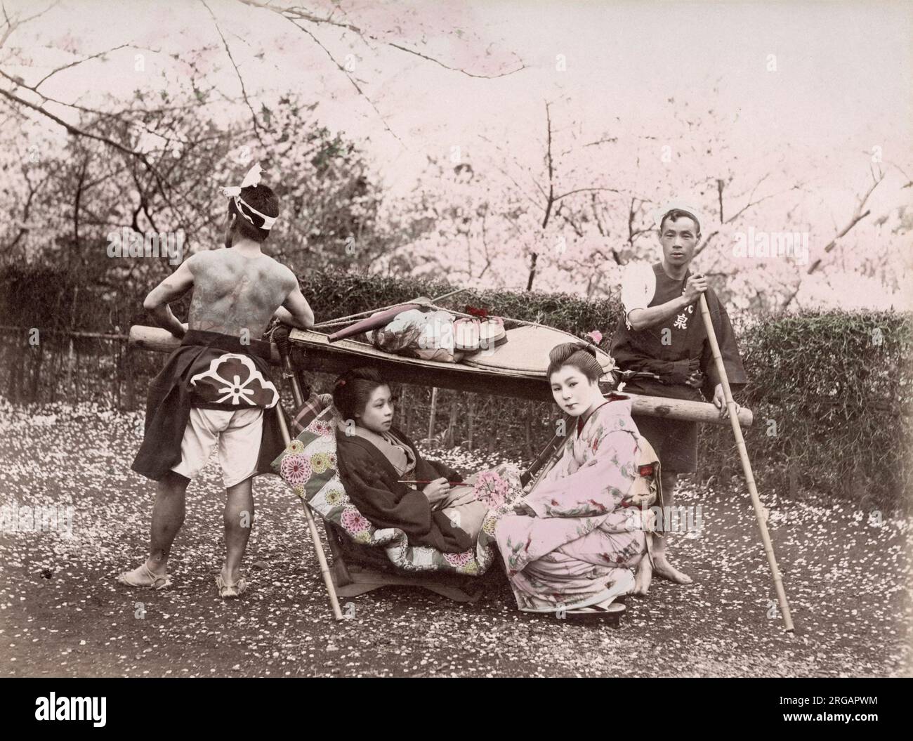 c. 1880s Japan - woman in sedan chair, tattooed bearers Stock Photo
