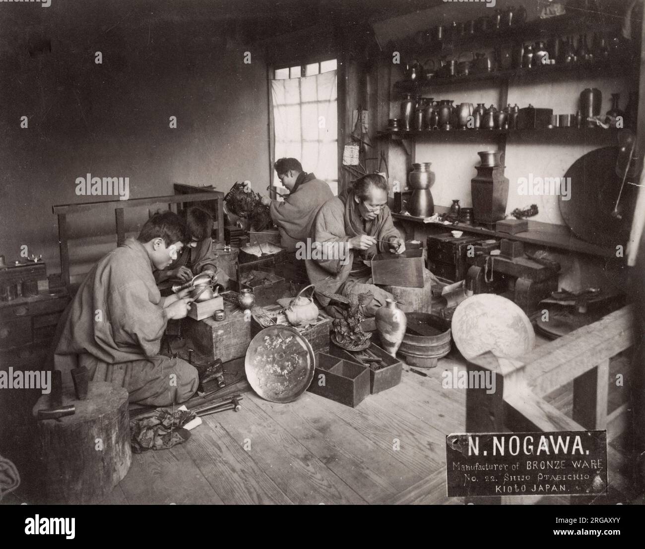 19th century vintage photograph - craftsmen making household and tourist items from bronze, Kyoto, Japan, c.1880's - workshop, studio of N. Nogawa. Stock Photo