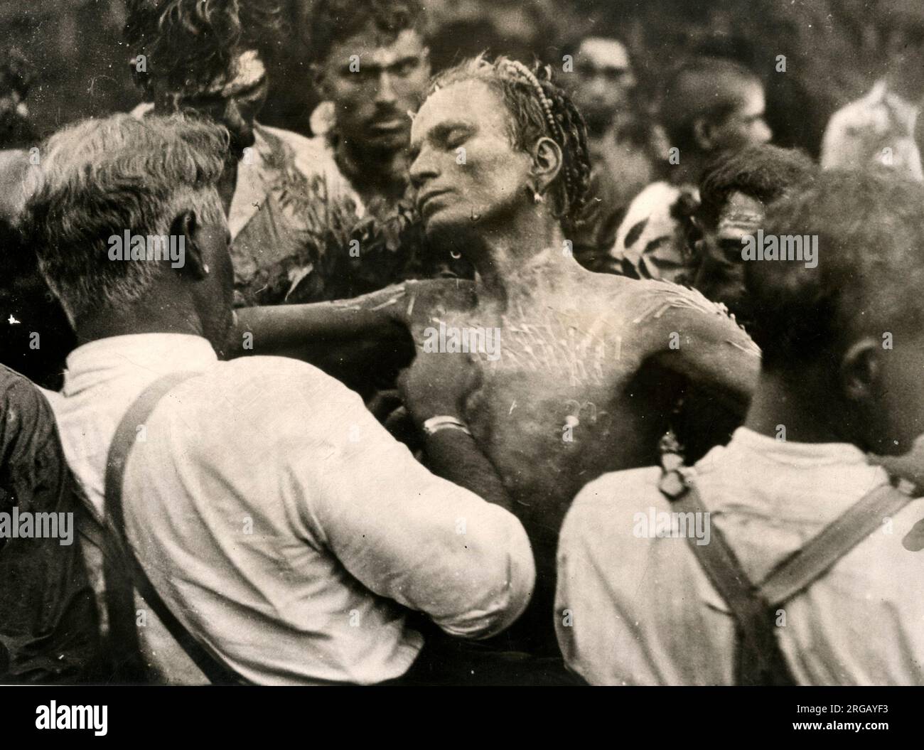 Fire walker Natal South Africa c.1920 - man in a trance with 500 pins being inserted in his skin Stock Photo