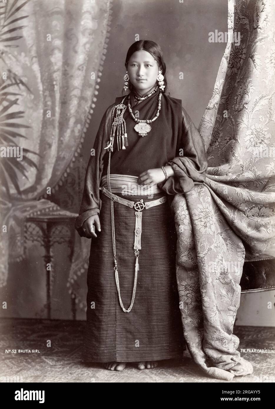 Vintage 19th century photograph - Bhutia girl. The Bhutia constitute a majority of the population of Bhutan, where they live mainly in the western and central regions of the country, and form minorities in Nepal and India, particularly in the Indian state of Sikkim; the likely location for this image. Stock Photo