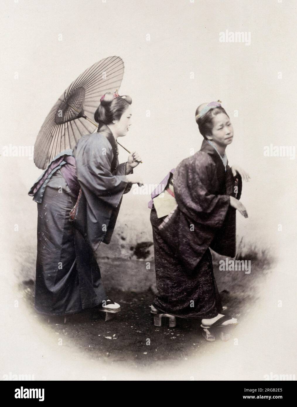 1860's Japan - portrait of a two young women in the pose of the Grecian Bend Felice or Felix Beato (1832 - 29 January 1909),  Italian-British photographer working mostly in India, Japan, China Stock Photo