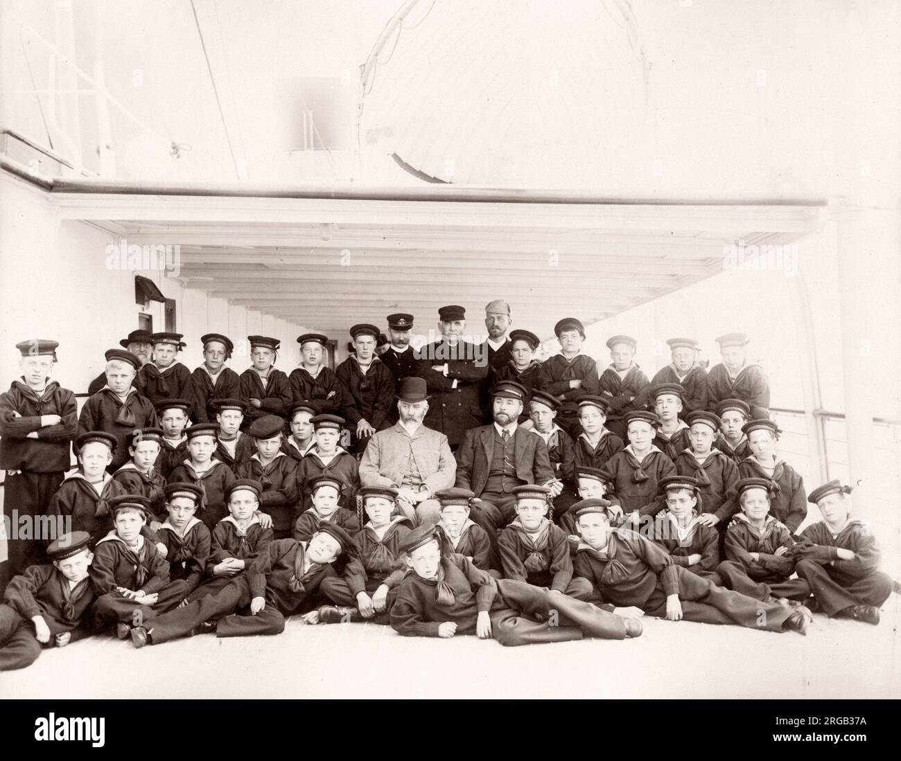 1889 photograph - RMS Teutonic - from an album of images relating to the launch of the vessel, which was built by Harland and Wolff in Belfast, for the White Star Line - later to achieve notoriety as the owner of the Titanic. The album shows interiors of the ship, member of the crew, trial cruises, including a visit onboard by the German Kaiser and Prince of Wales, as well as many images of other visitors. This image - boys of the training ship Indefatigable Stock Photo