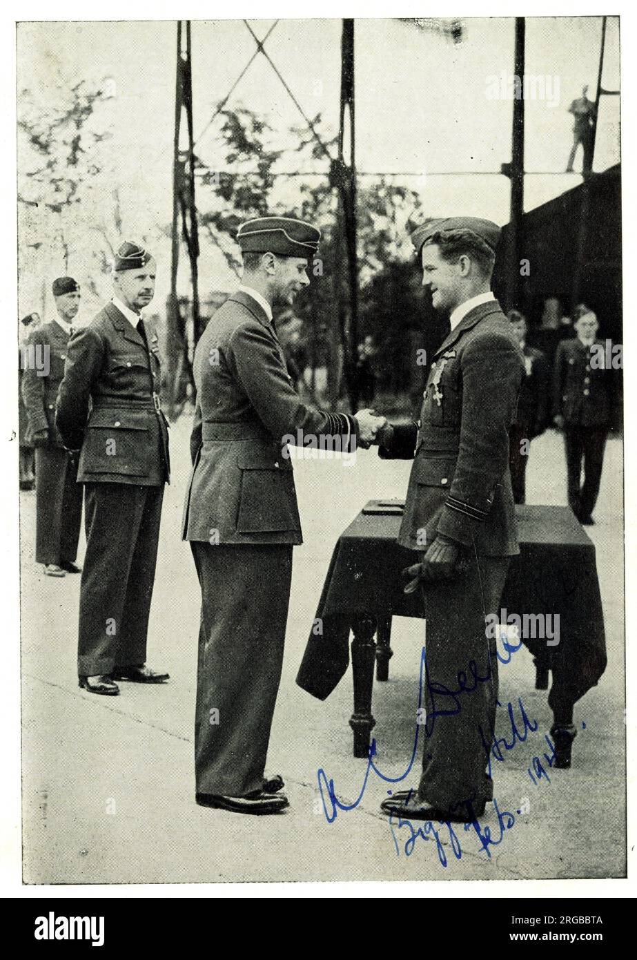 King George VI decorating Squadron Leader A.C. Deere, New Zealand Fighter Pilot, autographed, during the Second World War. Stock Photo