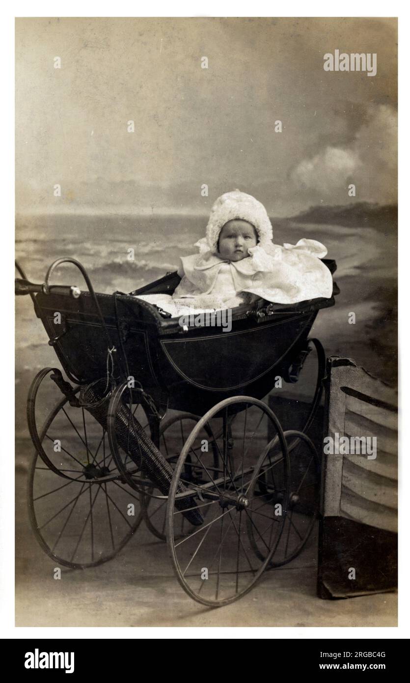 A very bonny baby in an extremely fine late Victorian / very early Edwardian perambulator. Stock Photo