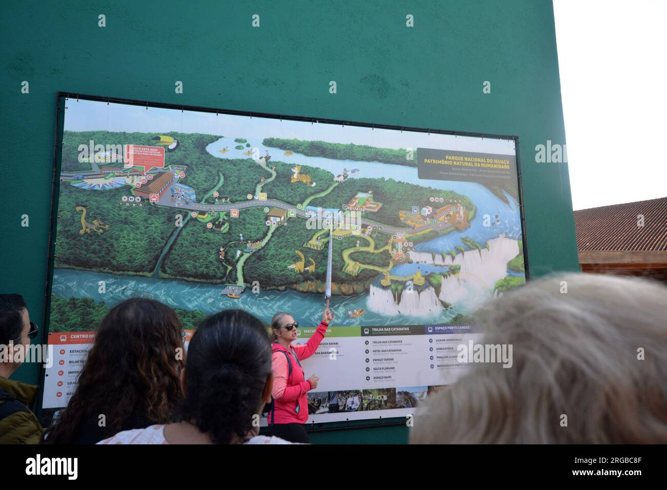 our guide showing the map with details of the Iguazu Falls to tourists on visiting days. Brazil Stock Photo