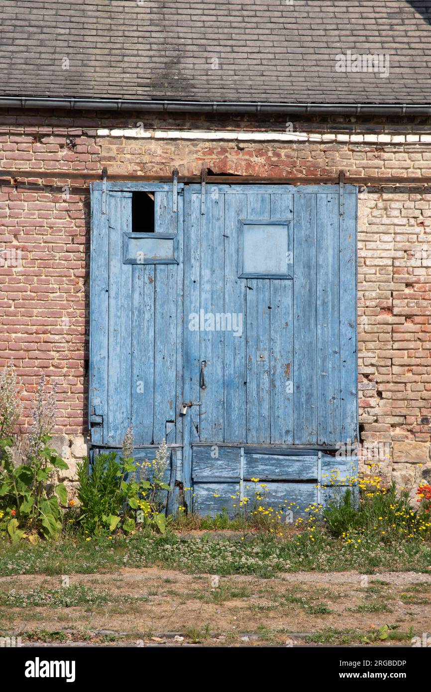 Sliding door of old commercial building in Saint Valery sur Somme Stock Photo