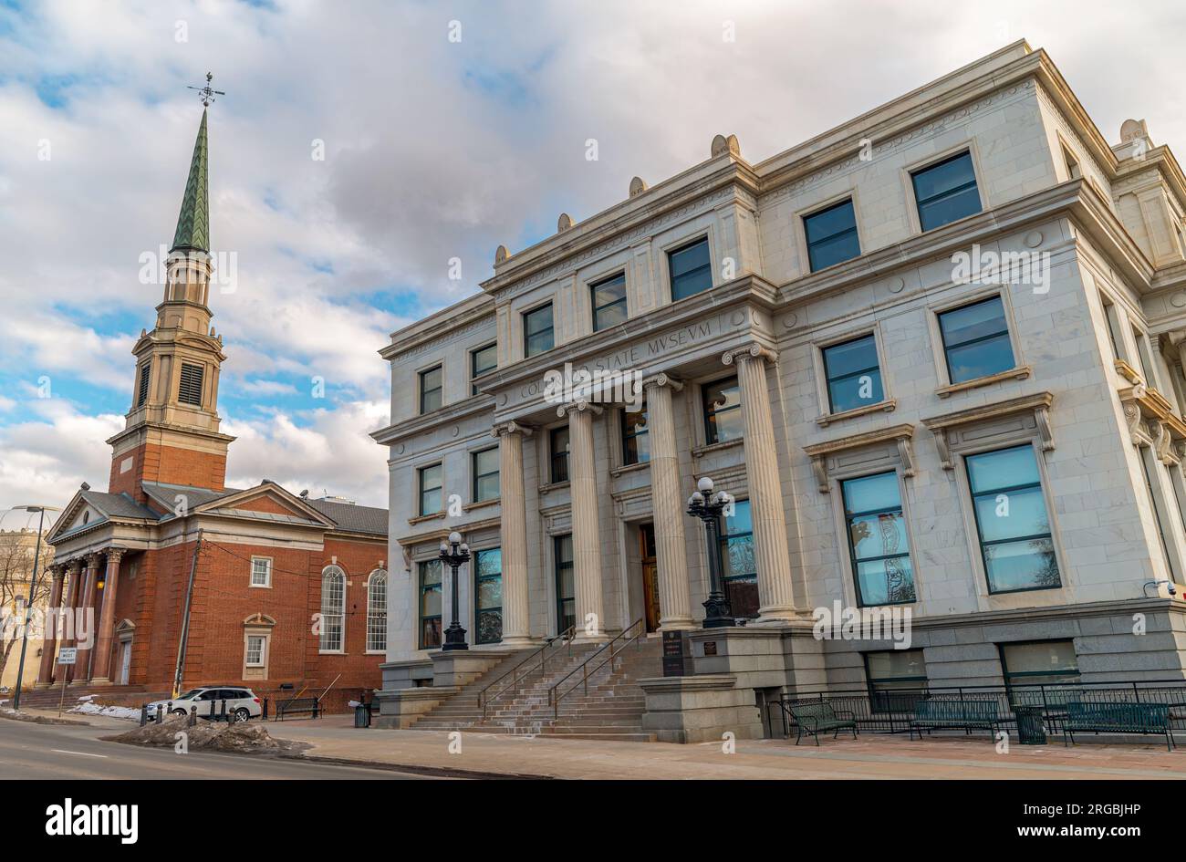 The historic state museum in downtown Denver, Colorado next door to a high reaching old church steeple. Stock Photo