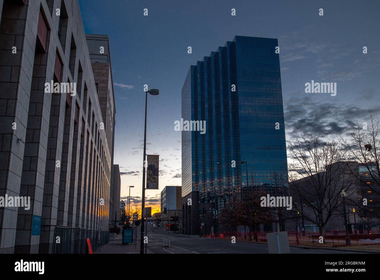The sun rises in the eastern sky on an early Sunday morning in downtown Denver with the streets still quiet and empty. Stock Photo