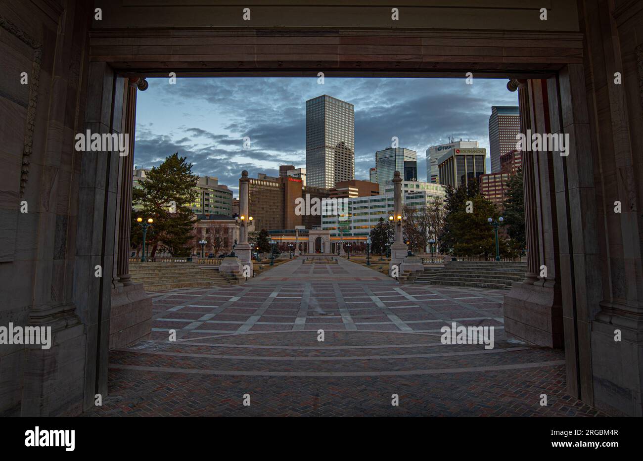 A beautiful portal type view of downtown Denver, Colorado through the amphitheater at Civic Center Park in early morning with no traffic. Stock Photo
