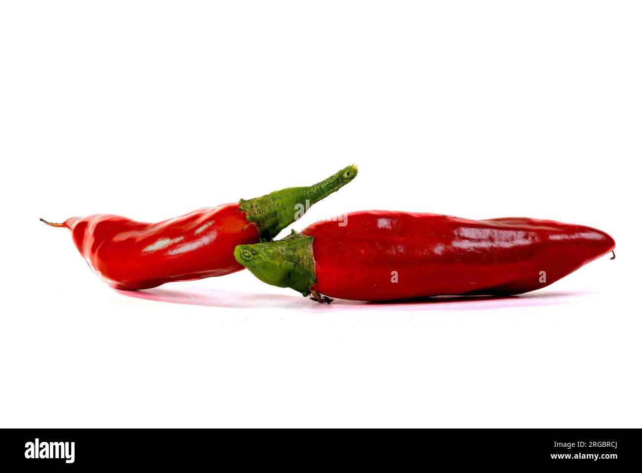 Two ripe red chili peppers isolated on white background Stock Photo - Alamy