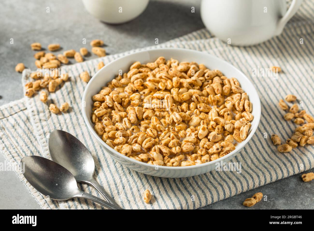 Healthy Sweet Puffed Wheat Breakfast Cereal and Whole Milk Stock Photo