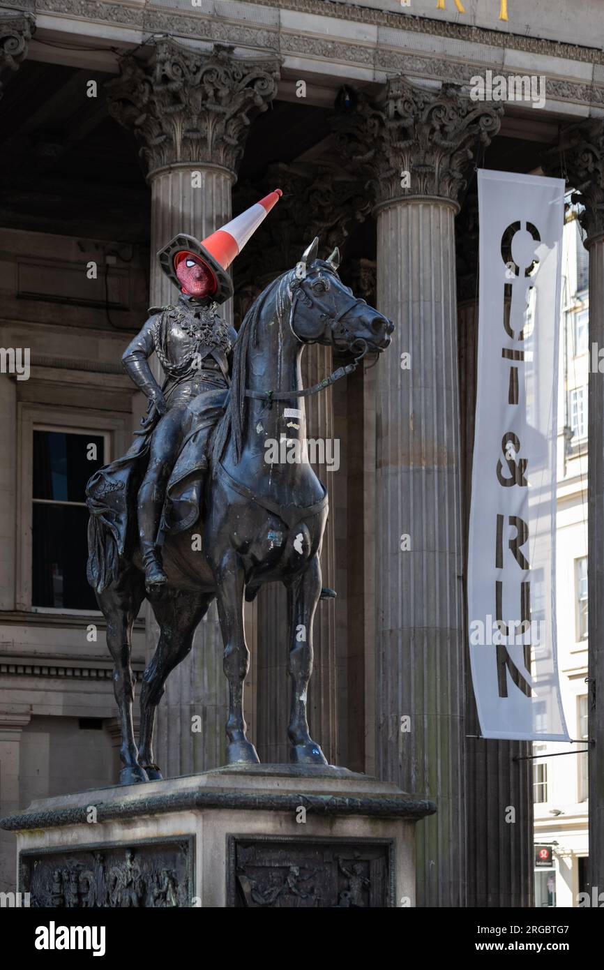 Duke of Wellington statue in Glasgow wearing a spiderman mask and cone