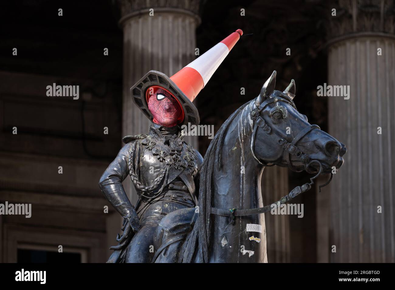 Duke of Wellington statue in Glasgow wearing a spider-man mask and cone outside the Banksy exhibition at Gallery of Modern Art - Glasgow, Scotland, UK Stock Photo