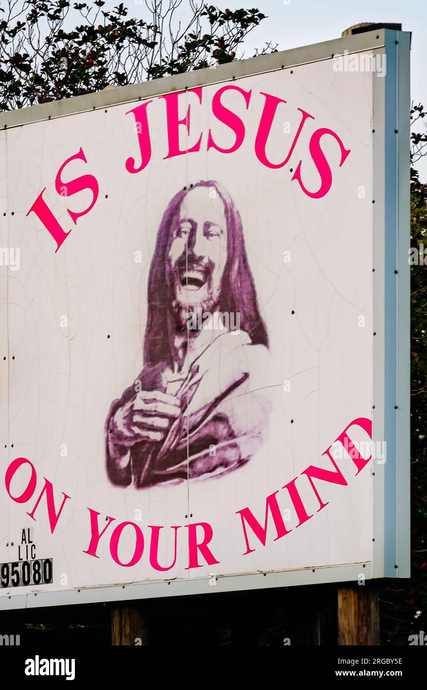 A religious message and picture of Jesus accompany an advertisement for a local repair service, Aug. 4, 2023, in Grand Bay, Alabama. Stock Photo