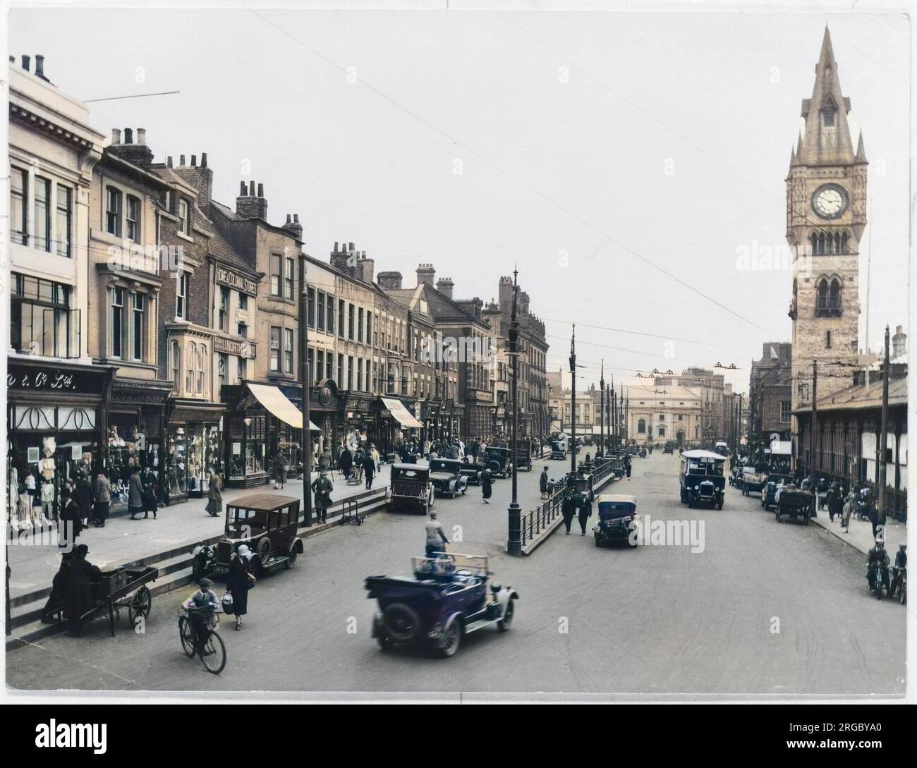 A view of High Row in Darlington, County Durham, showing a clock tower,traffic and shops. Stock Photo