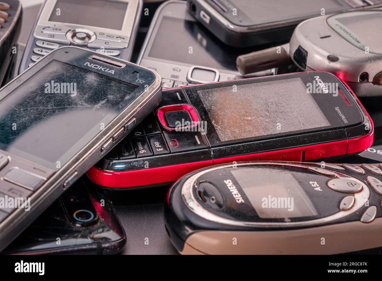 Opole, Poland - 08.07.2023 - Old mobile cell phones, close up. Nokia and Siemens old mobile vintage cellphones. Home-used and damaged Electronic waste Stock Photo