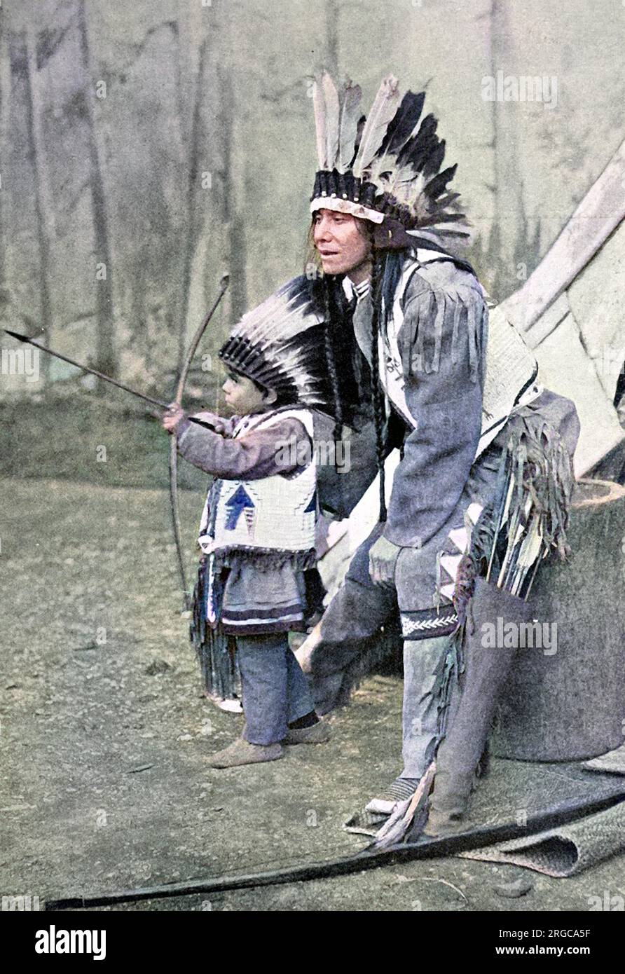 American Indian father and son with bows and arrows. Stock Photo