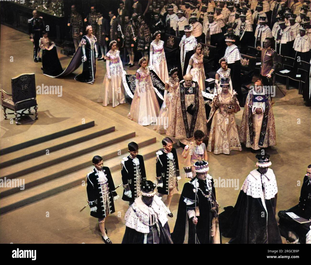 Coronation of Queen Elizabeth II. The Queen passing through Westminster Abbey wearing St Edward's crown and carrying the orb and sceptre. Stock Photo