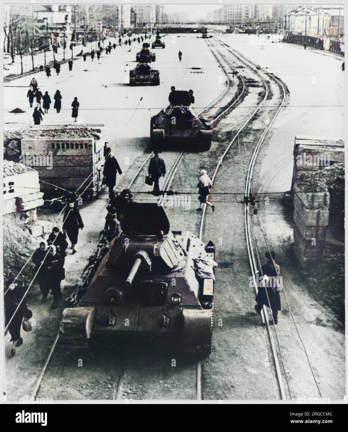 Tanks advance to battle positions along a city street. Stock Photo
