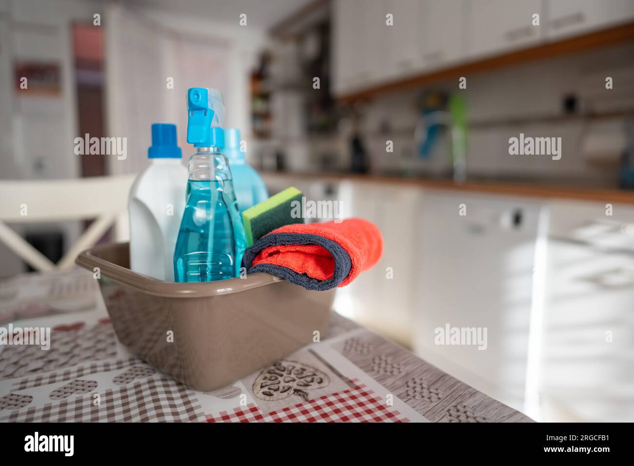 Set of household cleaning supplies ready to be used in the kitchen. Stock Photo