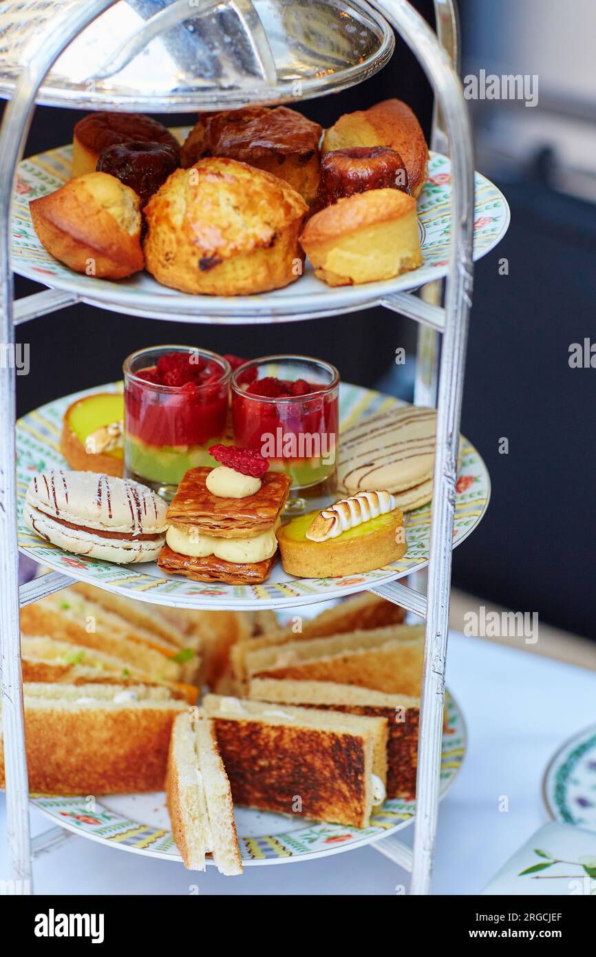 Selection of sandwiches and fancy cakes served for the ceremony of afternoon tea on a cakestand