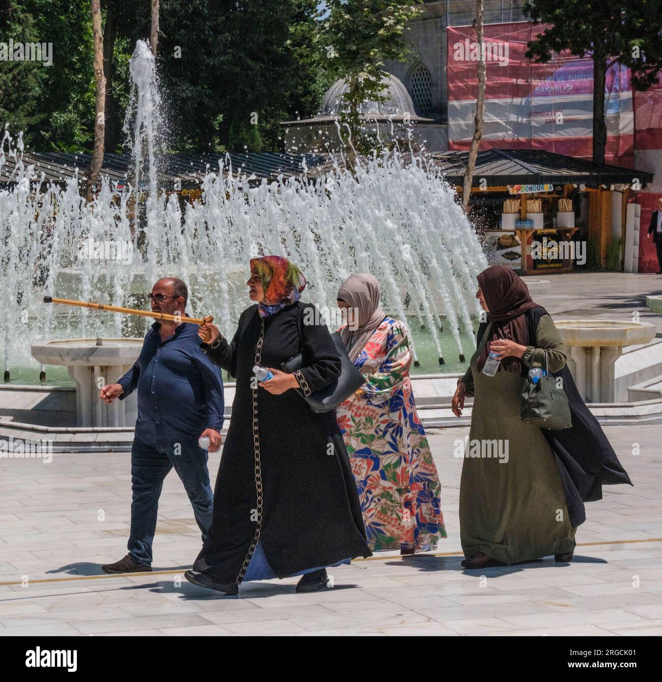 Istanbul, Turkey, Turkiye. Eyup Sultan Mosque,People Walking through the Outer Courtyard of the Mosque. Stock Photo